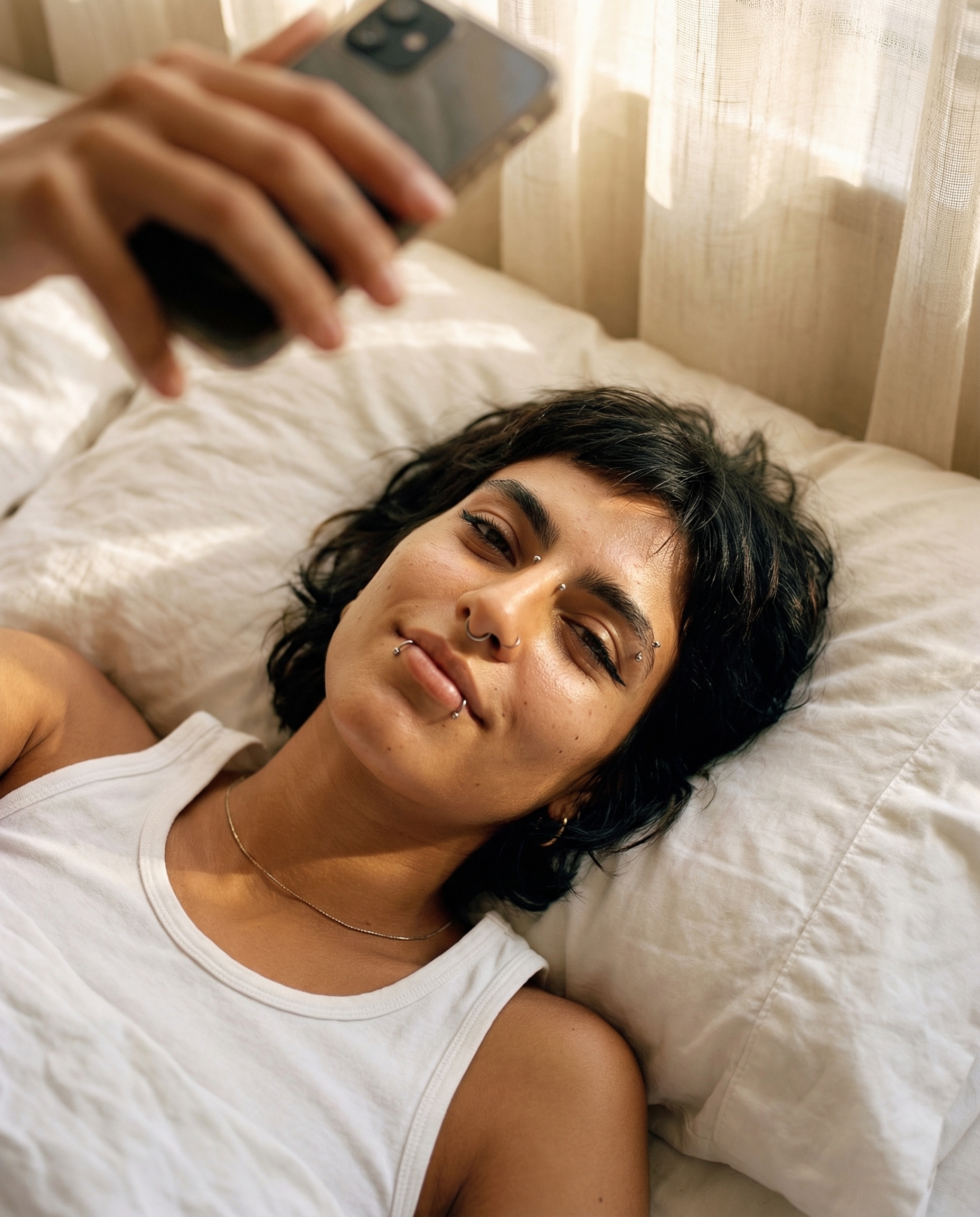 Morning bed selfie — natural light, relaxed pose
